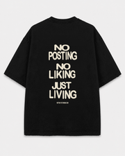 Back view of the black Just Living Tee with the bone-colored phrases NO POSTING, NO LIKING, and JUST LIVING, plus a small RETRO-FUTURISM.COM footer.