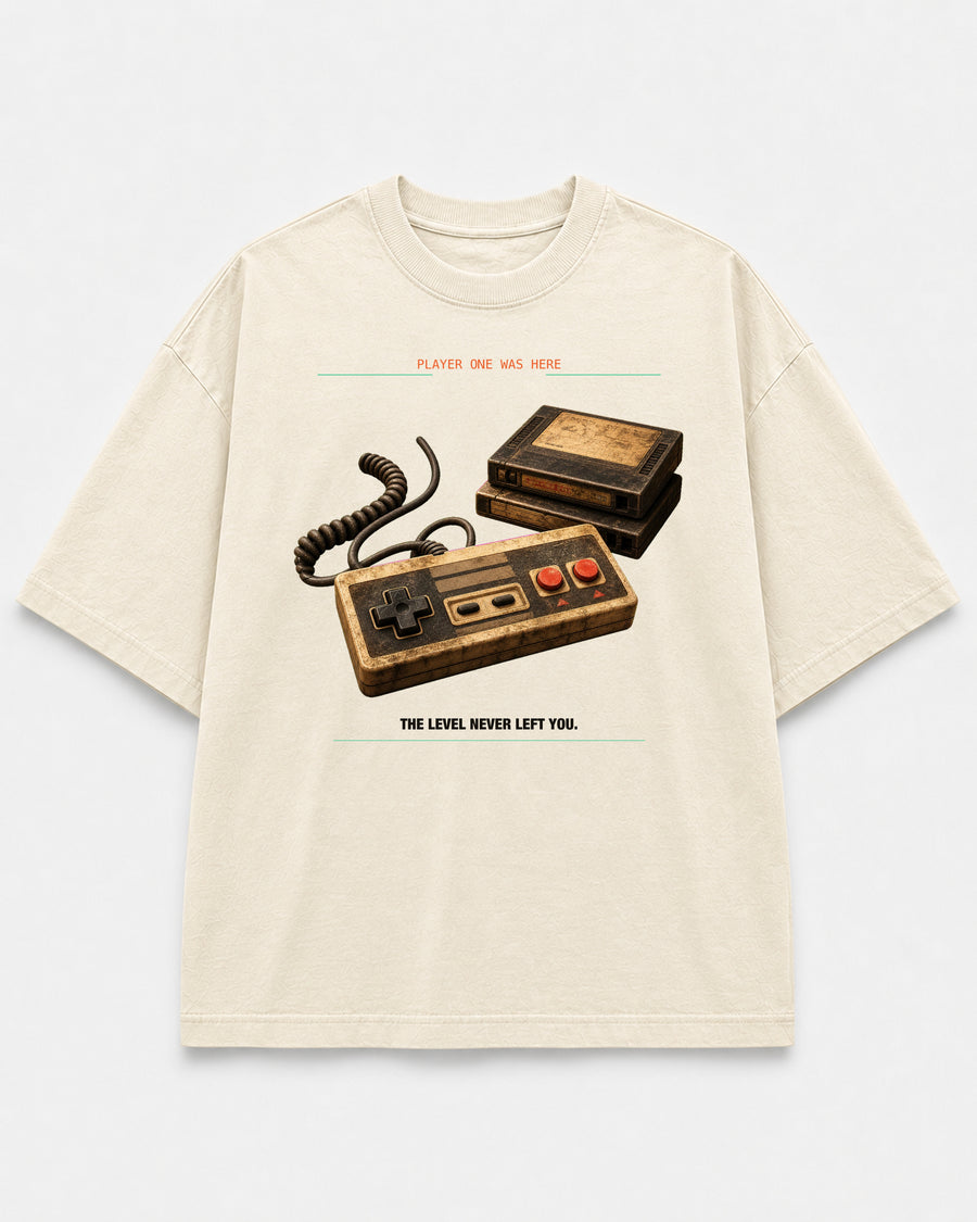 Save File Found Tee cream front mockup with worn retro game controller and cartridge artwork